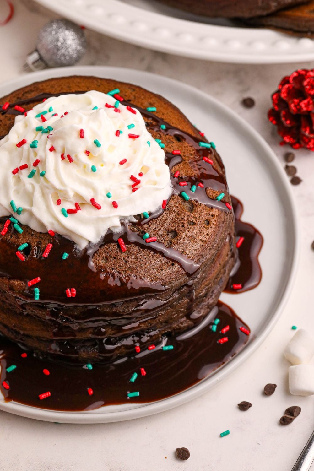 Hot Chocolate Pancakes on plates with sprinkles around the table