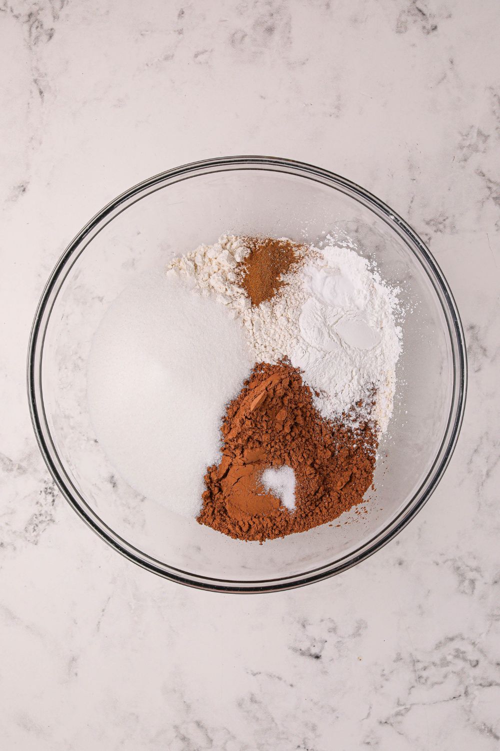 dry ingredients for Hot Chocolate Pancakes in a glass bowl on table
