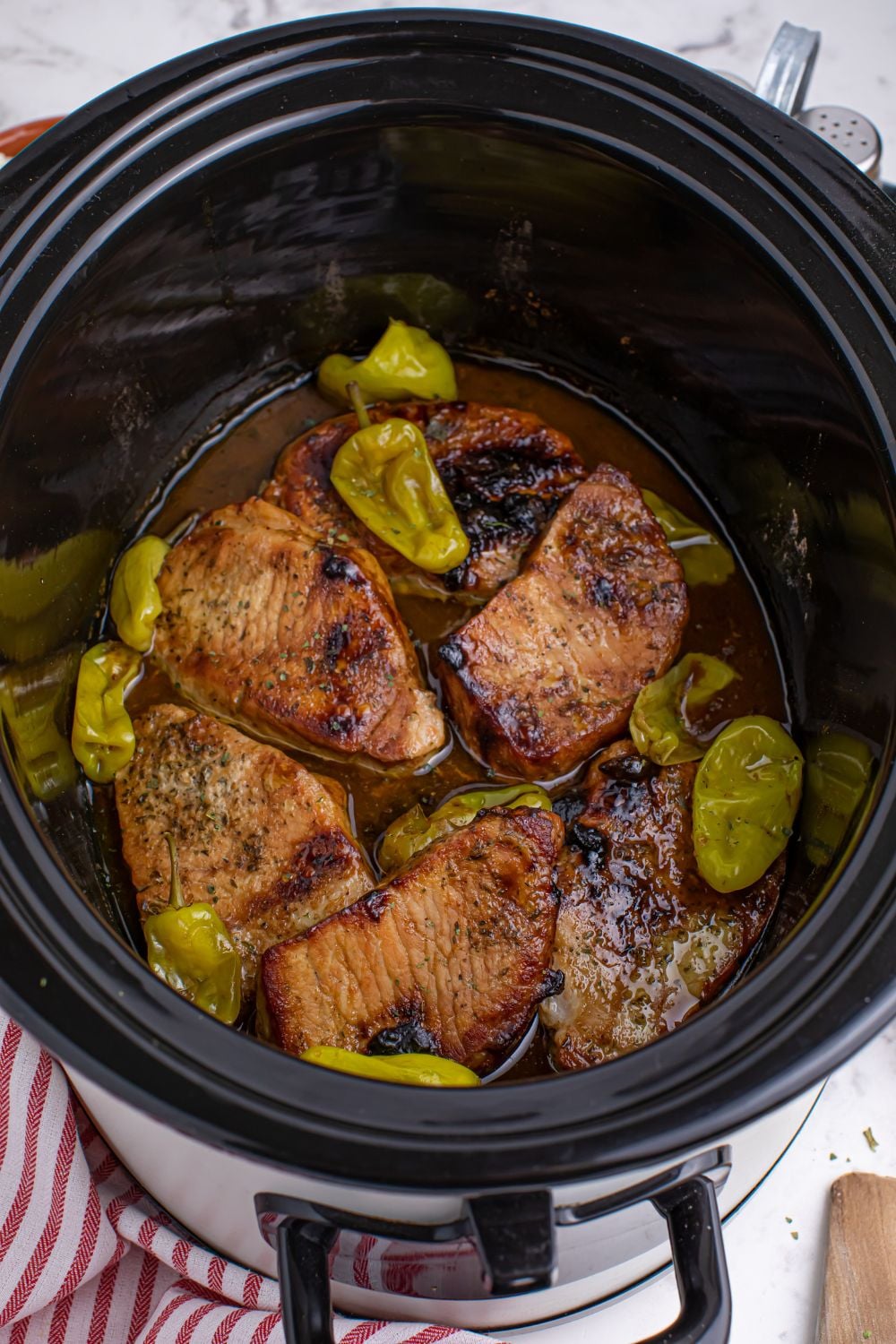 Crock Pot Mississippi Pork Chops - overhead look of pork chops and sauce in a slow cooker for crack pork chops