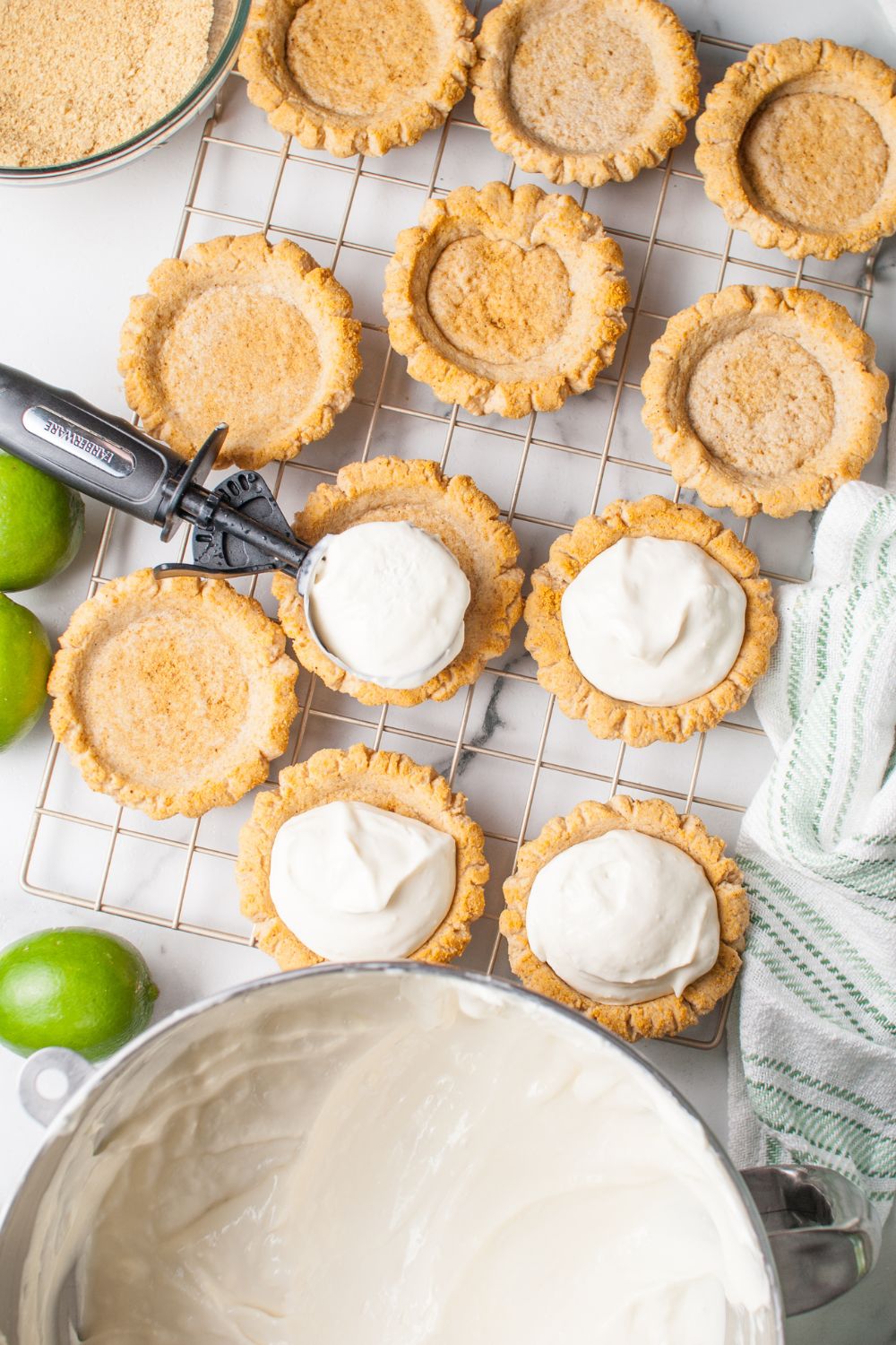 Crumbl Key Lime Pie Cookie filling being placed in the center of each cookie with the filling