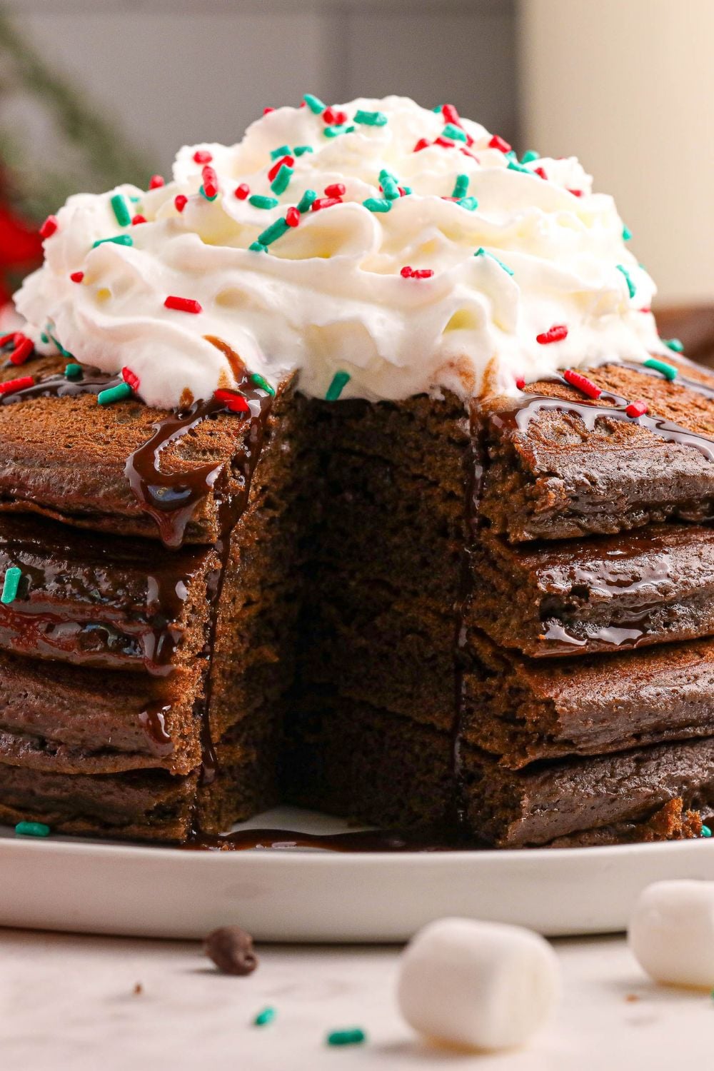 Hot Chocolate Pancakes on a plate with some of the pancake cut out of the pancakes