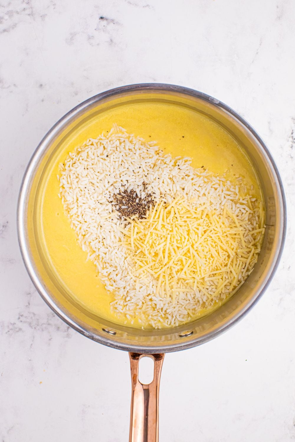 Souper Rice ingredients all poured into a saucepan sitting on the table