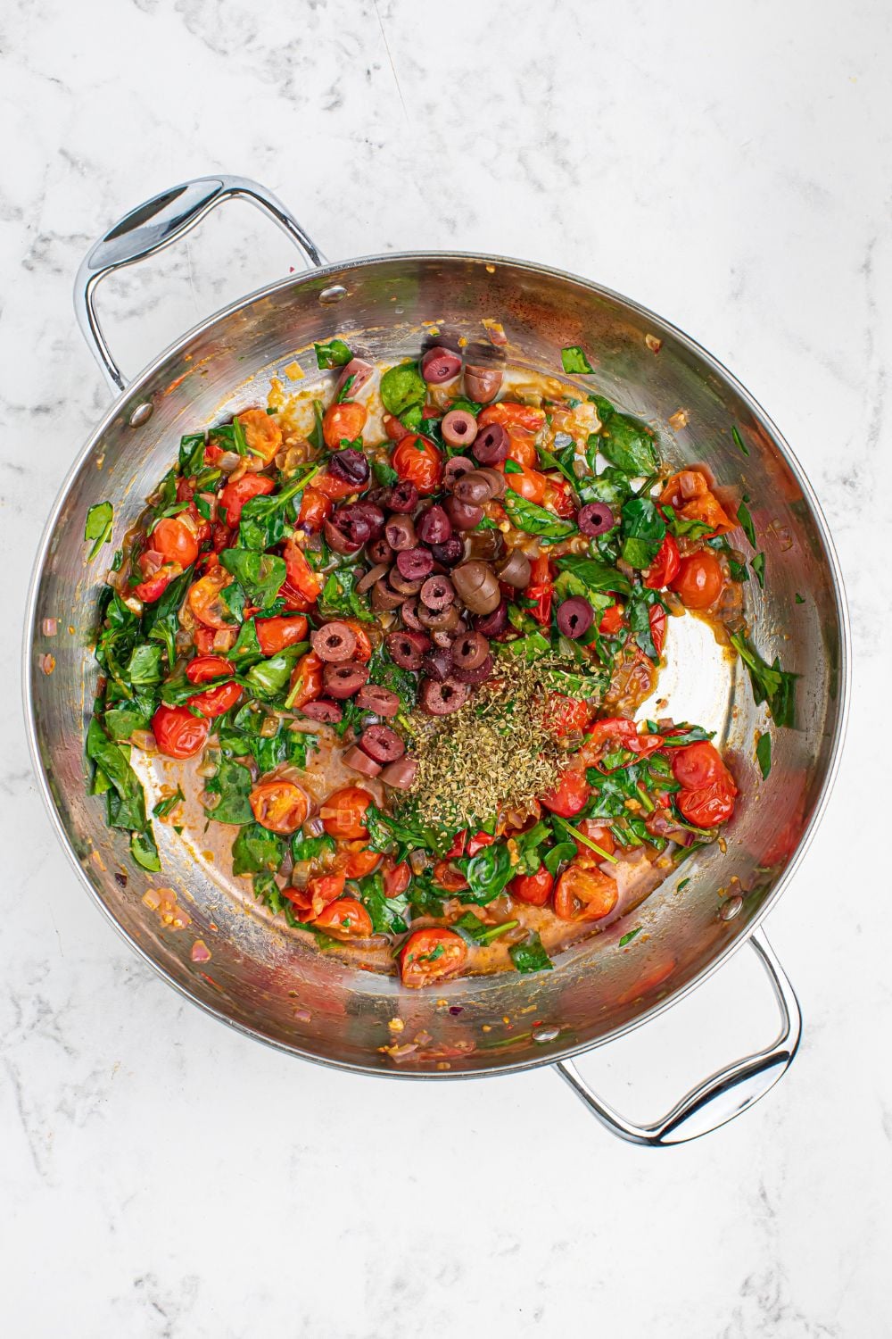 sauted vegetables for Greek Spaghetti in a pan on table 