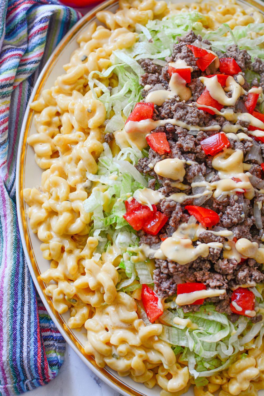 Big Mac Macaroni And Cheese side view of the dish stacked on top of each other on a platter