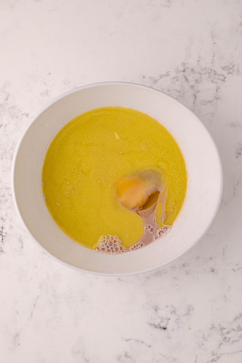 butter and egg in a mixing bowl on the table for Hot Chocolate Pancakes