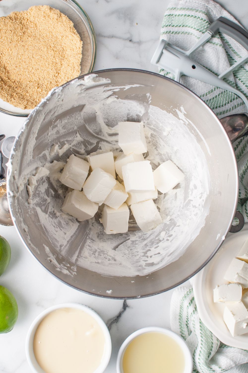 diced pieces of cream cheese in the bowl for making Crumbl Key Lime Pie Cookies