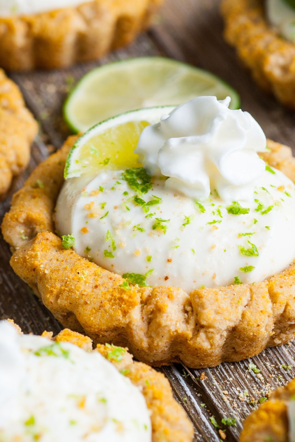 close up of Crumbl Key Lime Pie Cookies on table lined out in rows