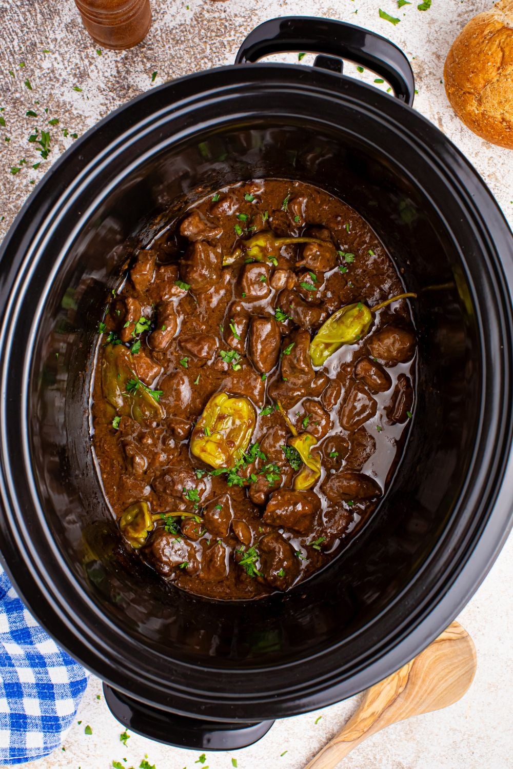Crockpot Mississippi Steak Bites overhead view of crockpot with parsley garnished on top