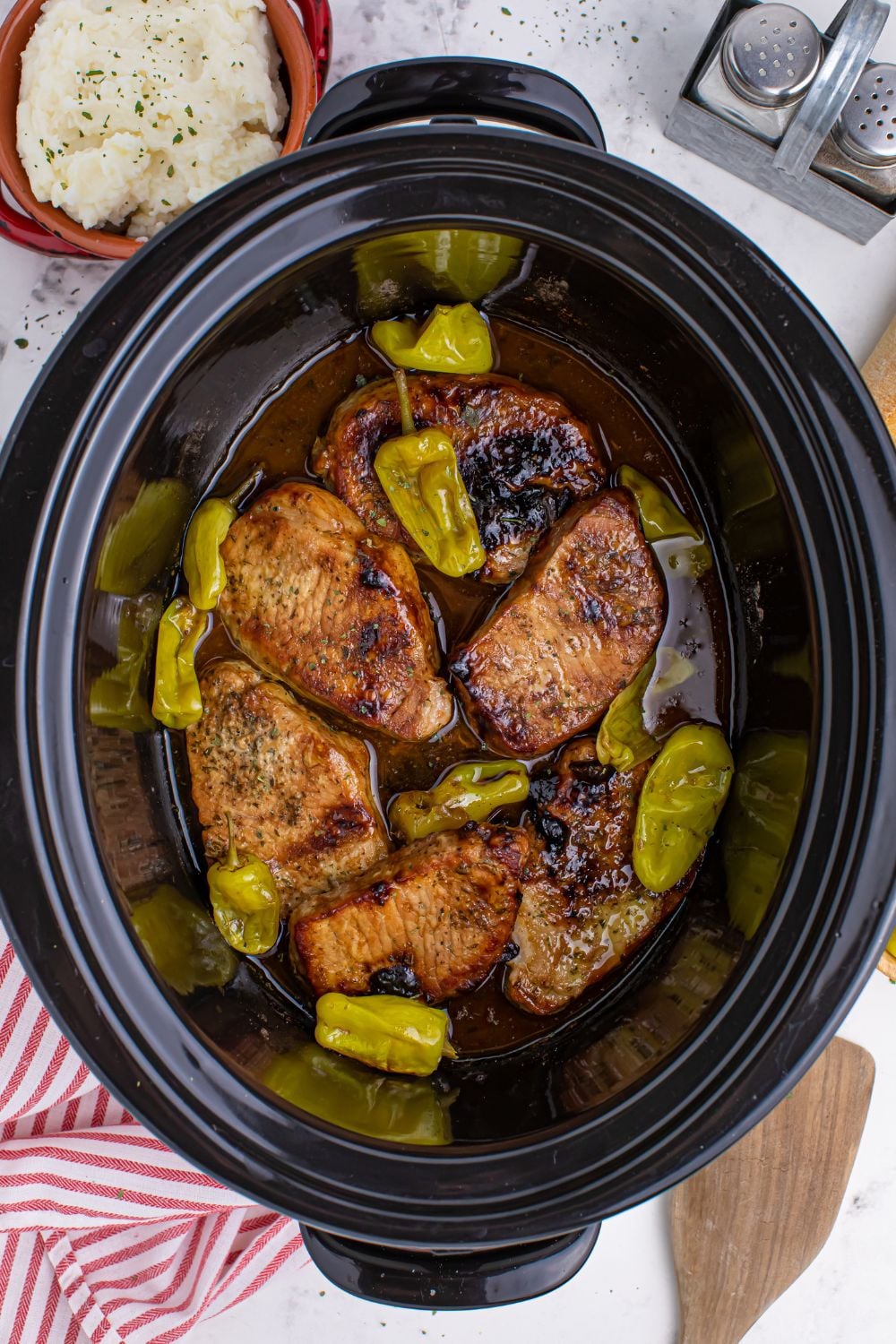 overhead look of Crock Pot Mississippi Pork Chops in a crock pot on table