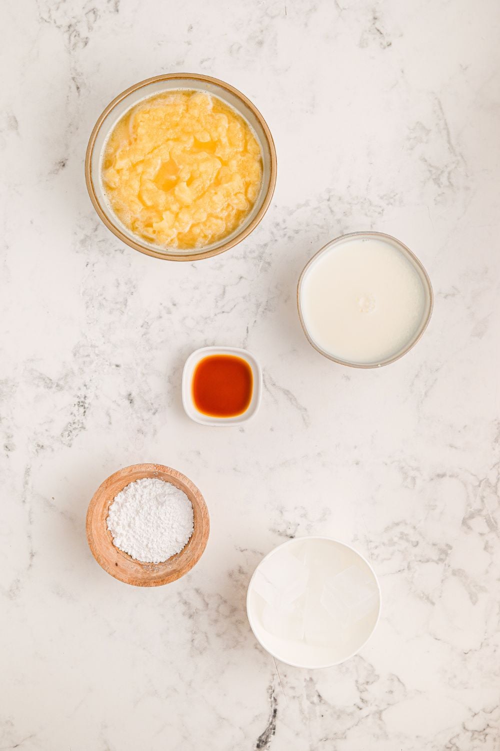 Copycat Orange Julius ingredients on table - orange juice concentrate, milk, powdered sugar, vanilla extract