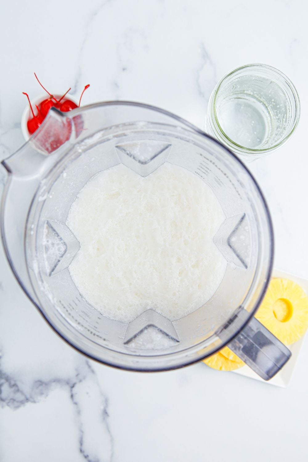 Pina Colada Punch ingredients in a blender on table 