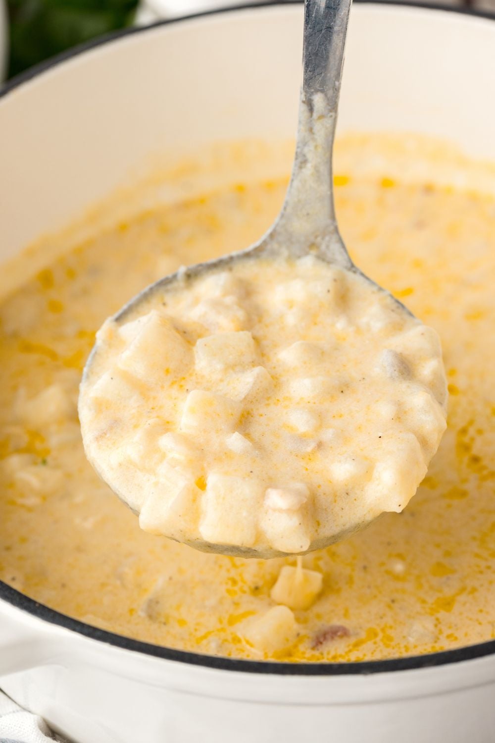 Hash Brown Potato Soup in a pan with a ladle of soup above pot