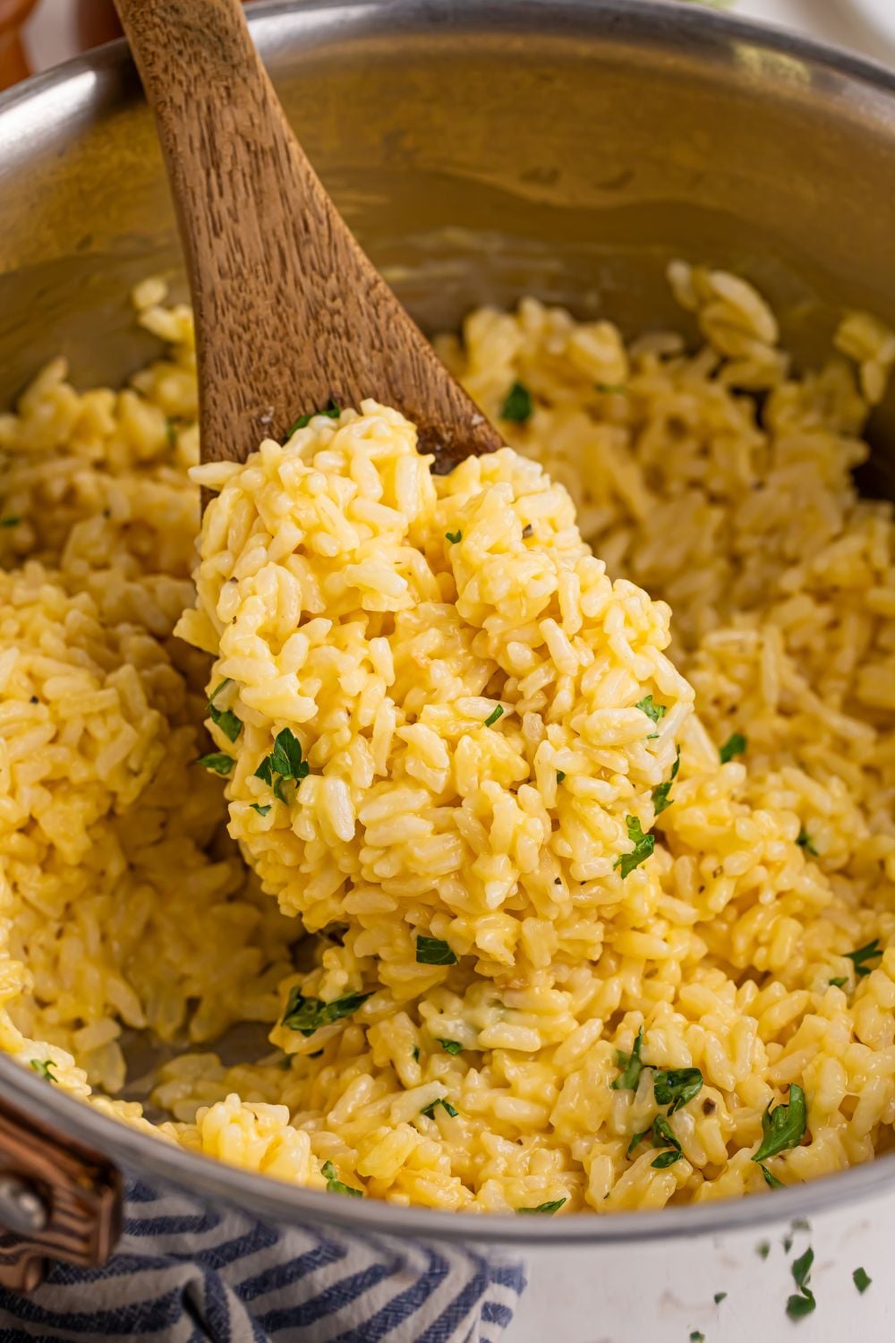 Souper Rice in a metal pan with a wooden spoon of rice in pan