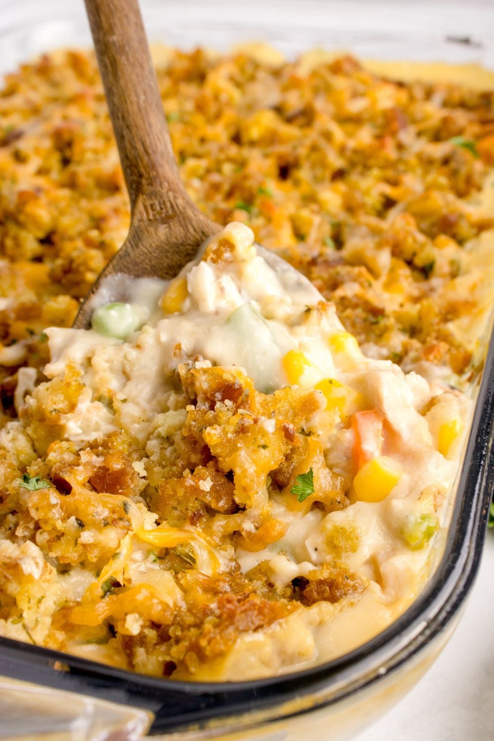 Chicken Stuffing Casserole with a scoop being lifted out of the casserole dish