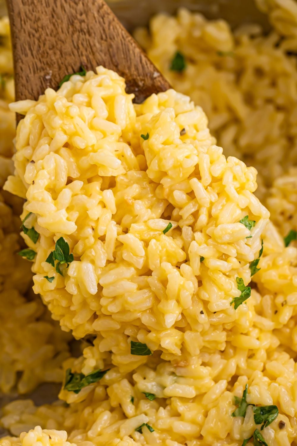 Souper Rice being scooped out of pan with a wooden spatula