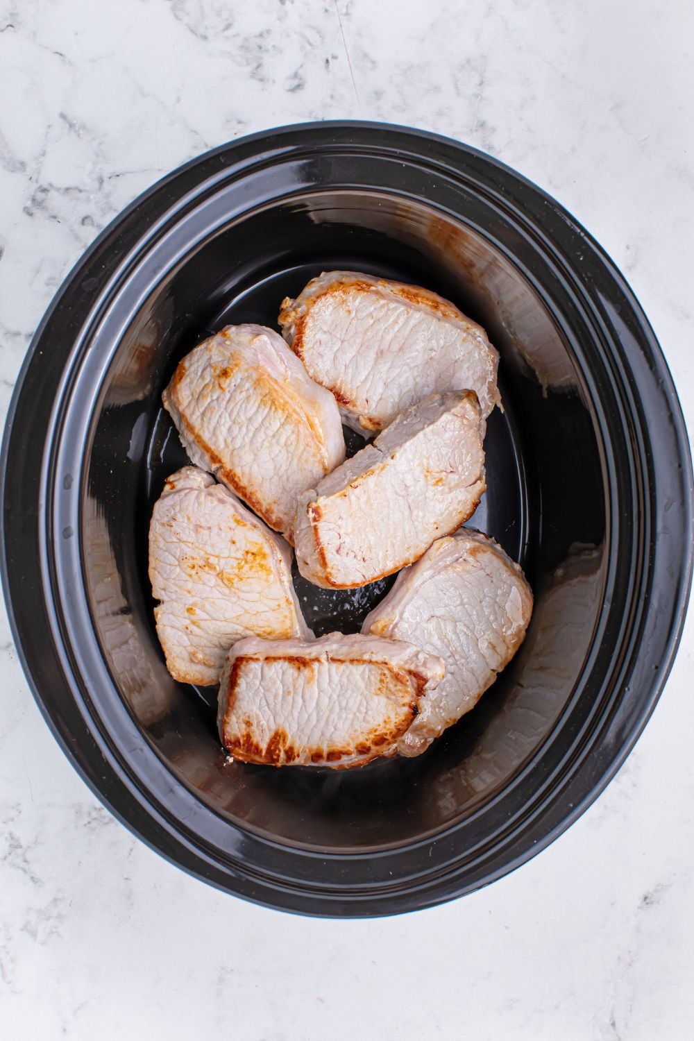 Crock Pot Mississippi Pork Chops in a slow cooker on the table