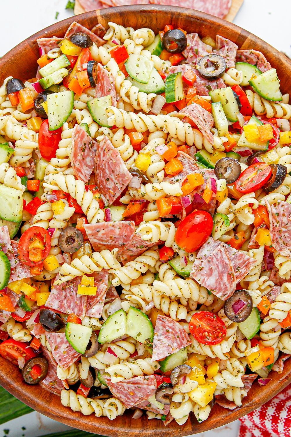 Summer Pasta Salad in a wooden bowl with overhead shot of it on table 