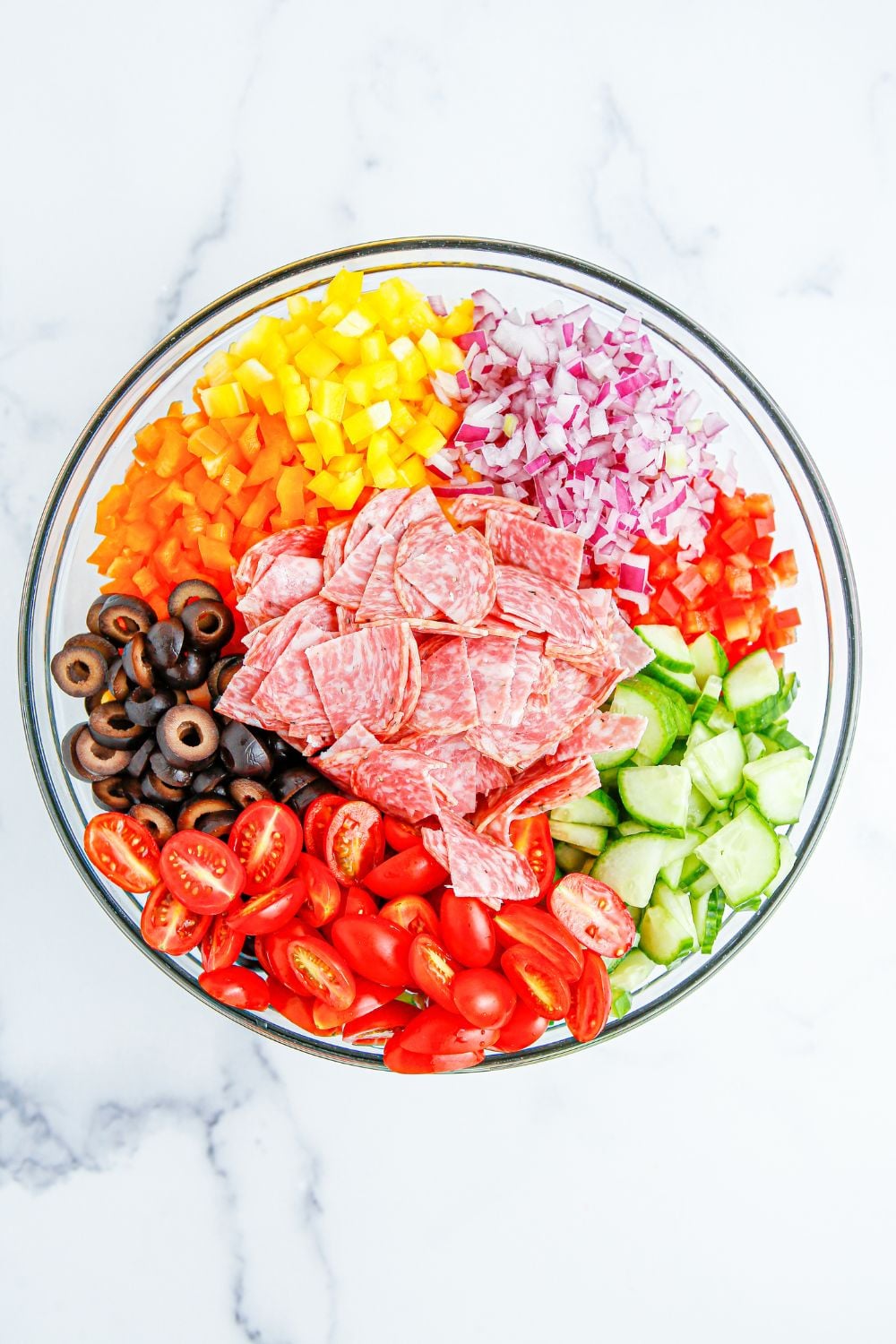 Summer Pasta Salad mix in a bowl all ingredients are in single areas in bowl 