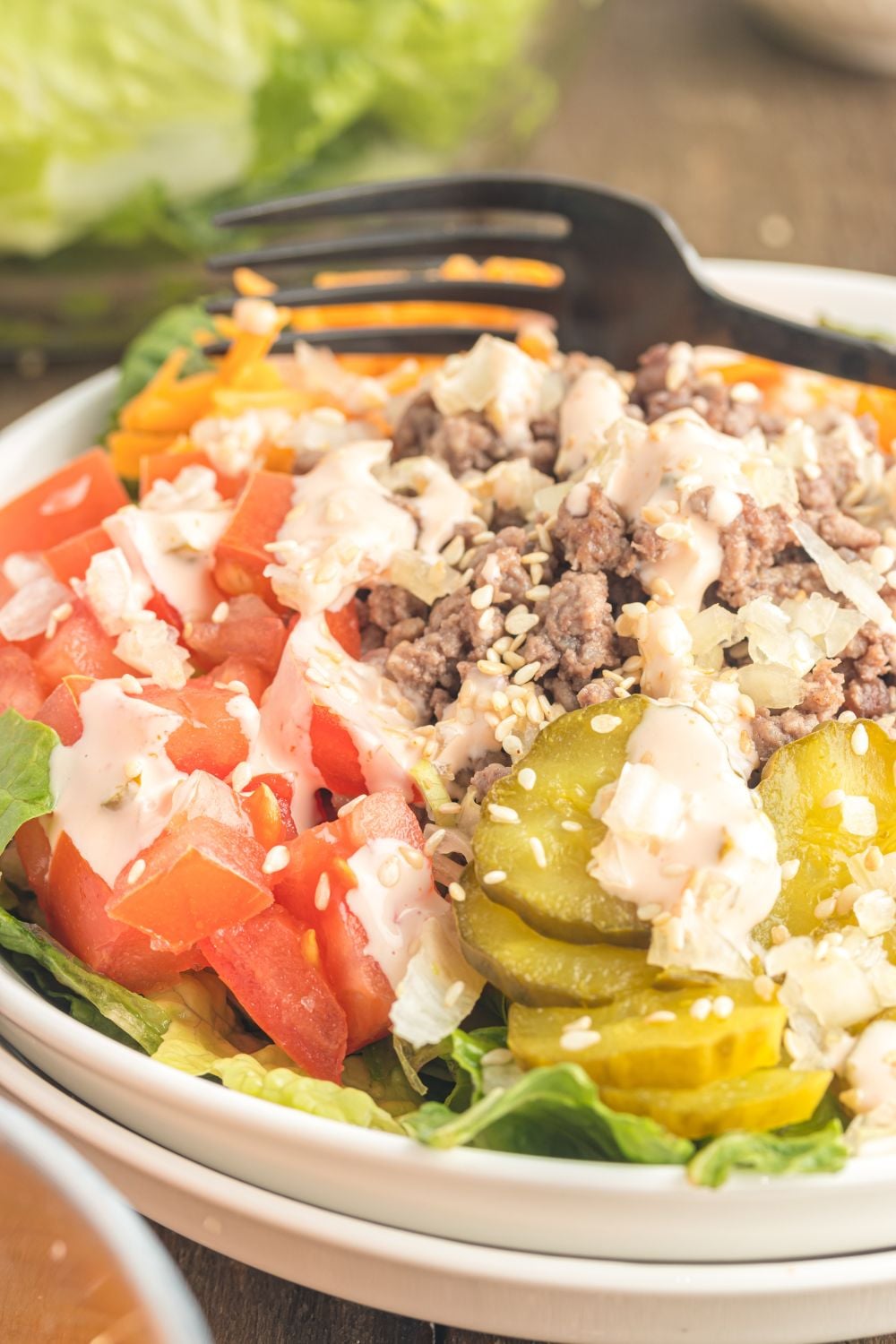 Big Mac Salad in a bowl with a black fork on the side of the bowl 