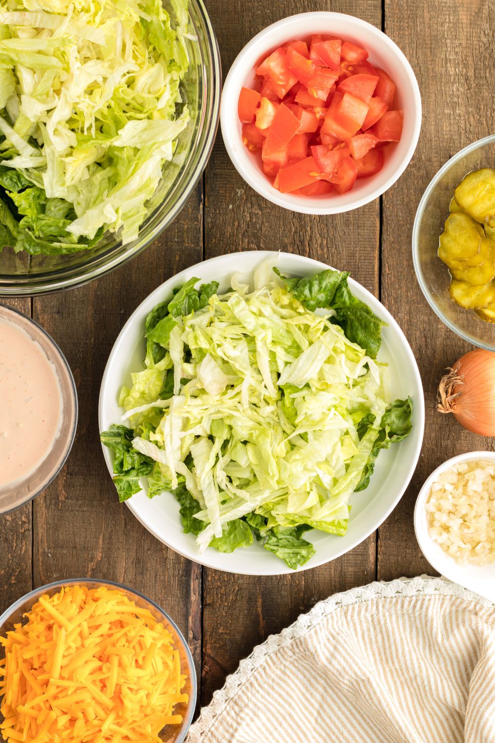 green lettuce mix on a plate for assembling Big Mac Salad 
