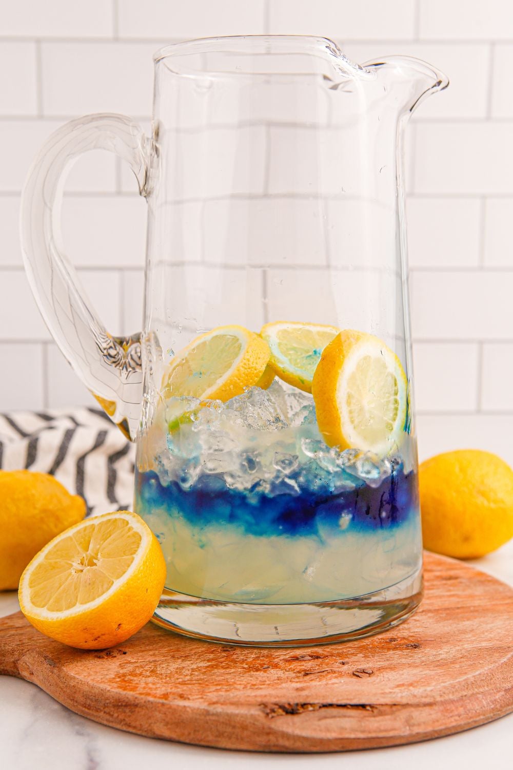 blue raspberry syrup poured in glass pitcher for Blue Raspberry Lemonade