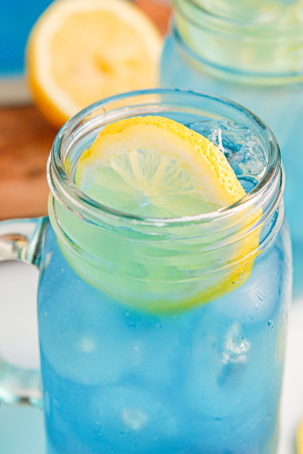 close up of Blue Raspberry Lemonade in a glass with a lemon wheel on top