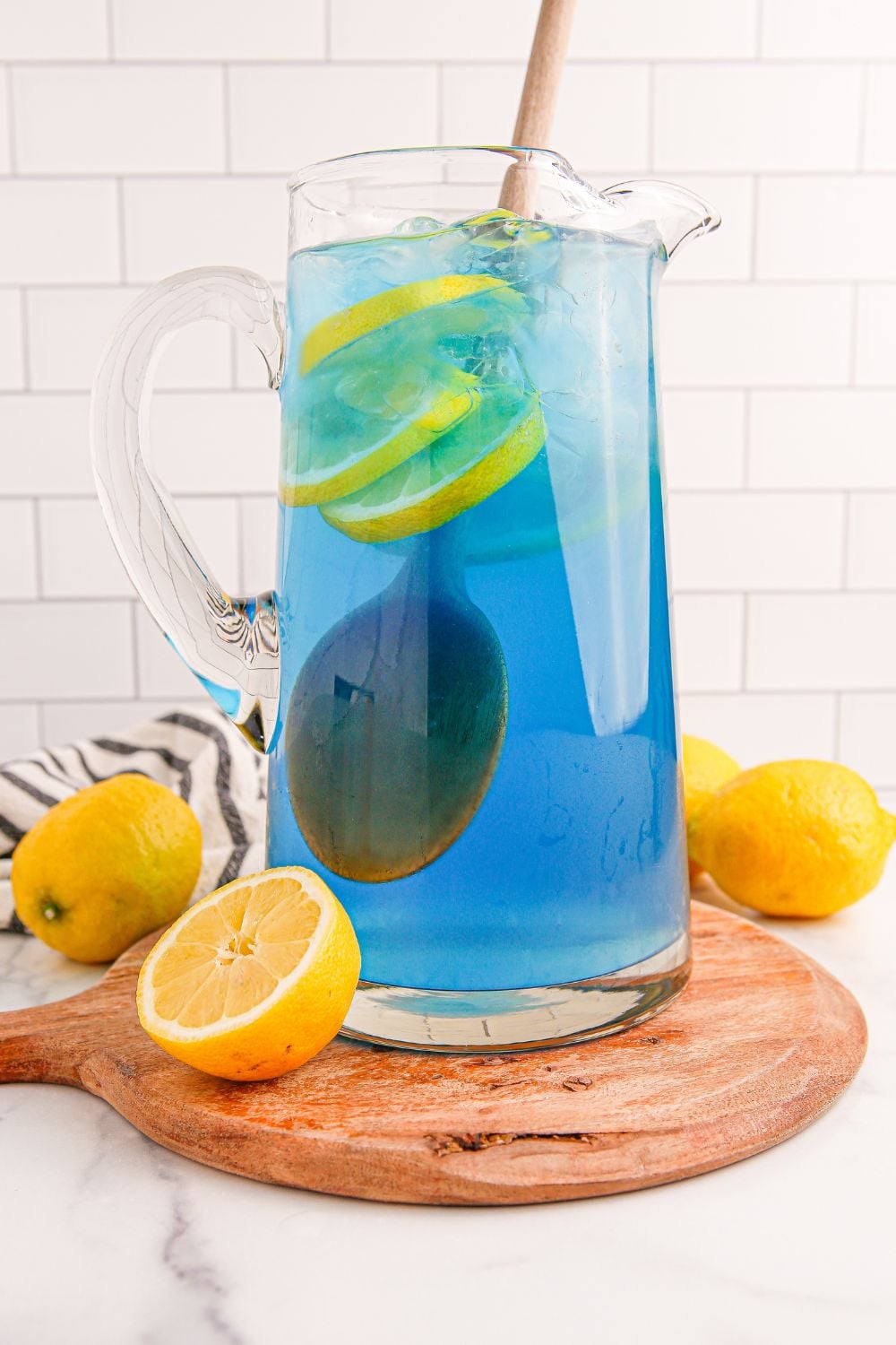 Blue Raspberry Lemonade in a pitcher with a spoon in it