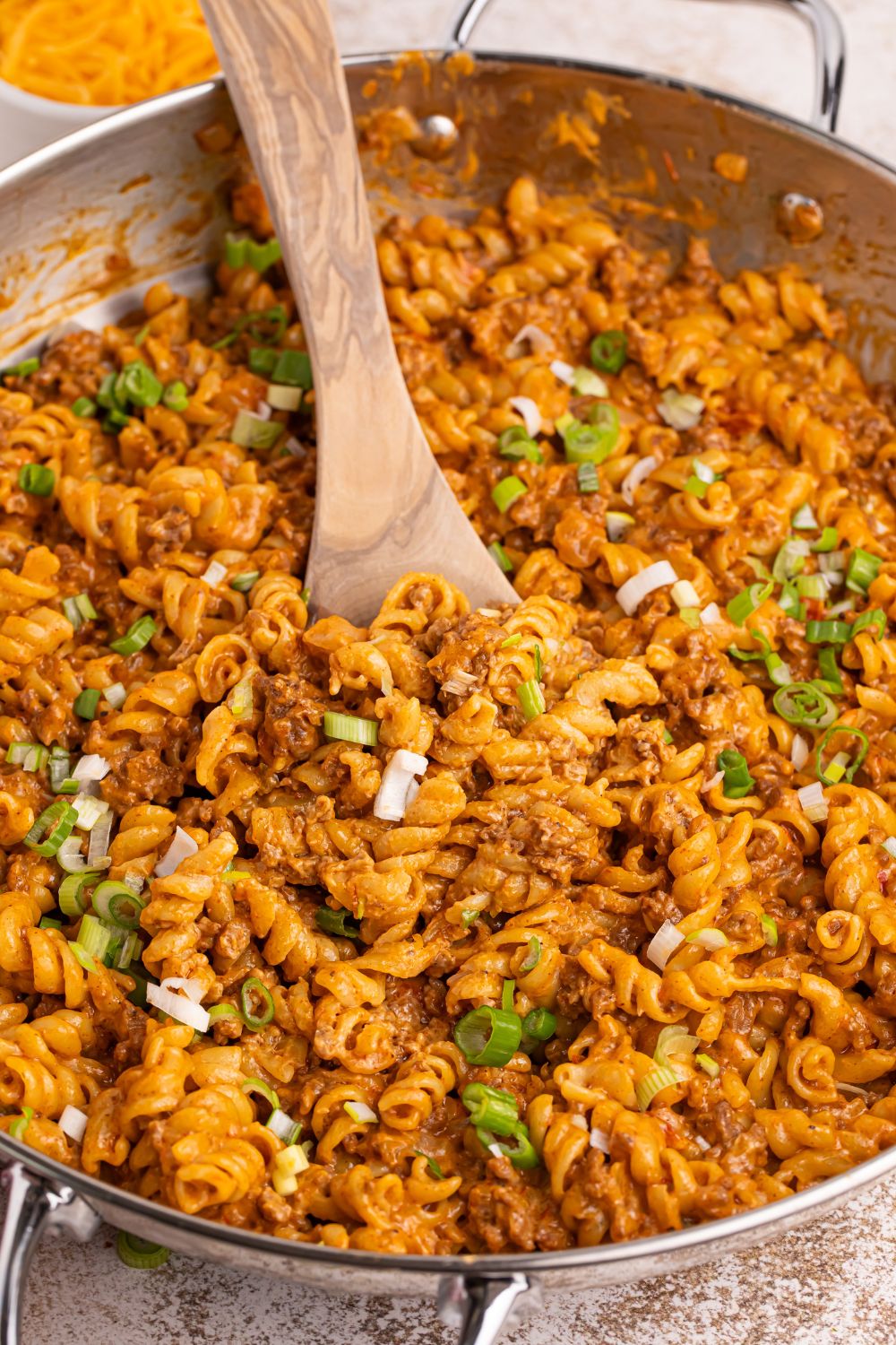 Taco Macaroni and Cheese in a pan with a spoon in the pan