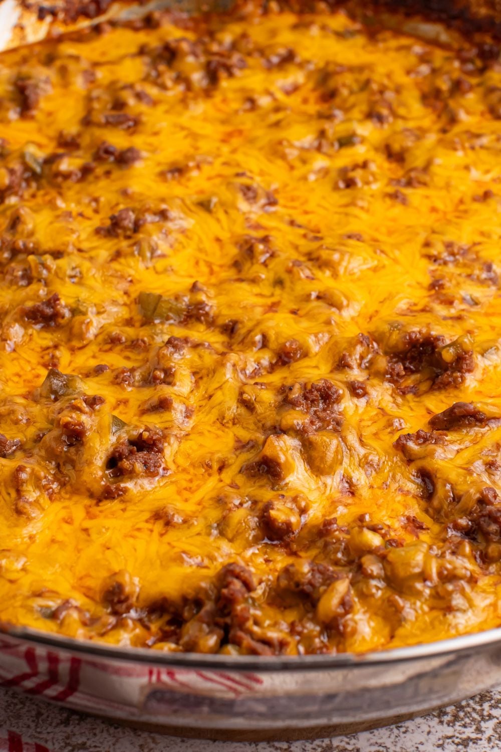 Sloppy Joe Dip with melted cheese on top in a pan