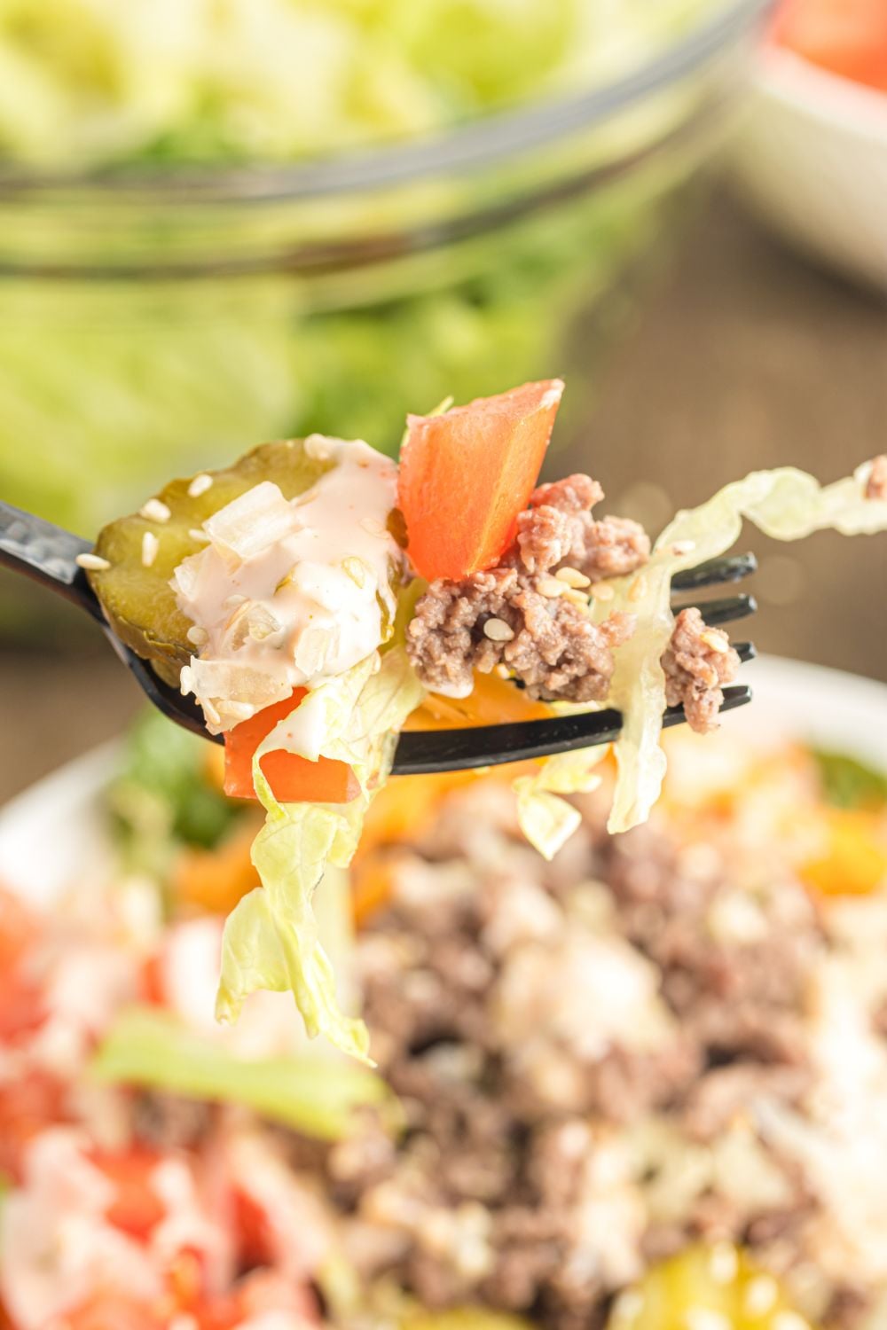 Big Mac Salad on table with a fork full of the salad to show a close up view 