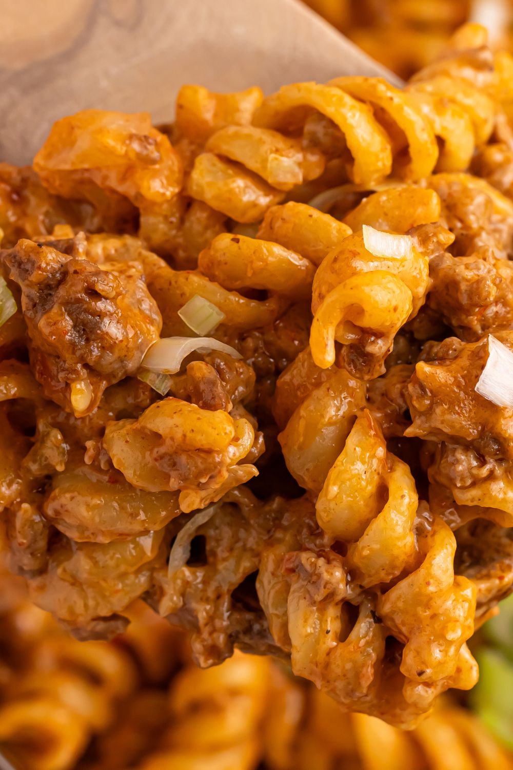 Taco Macaroni and Cheese in a pan with a close up of pasta in a pan