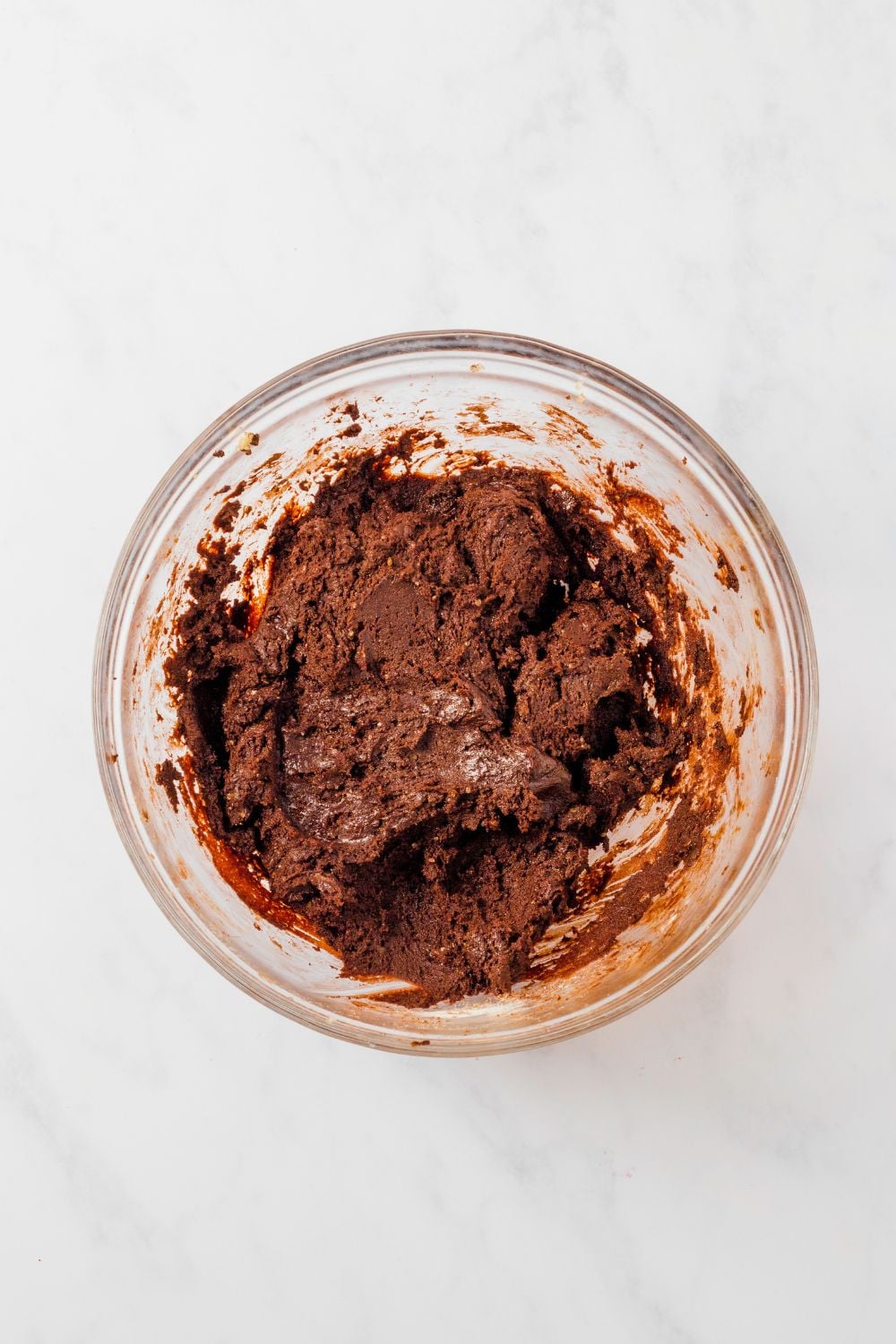 Chocolate M&M Cookie dough in a glass bowl on table