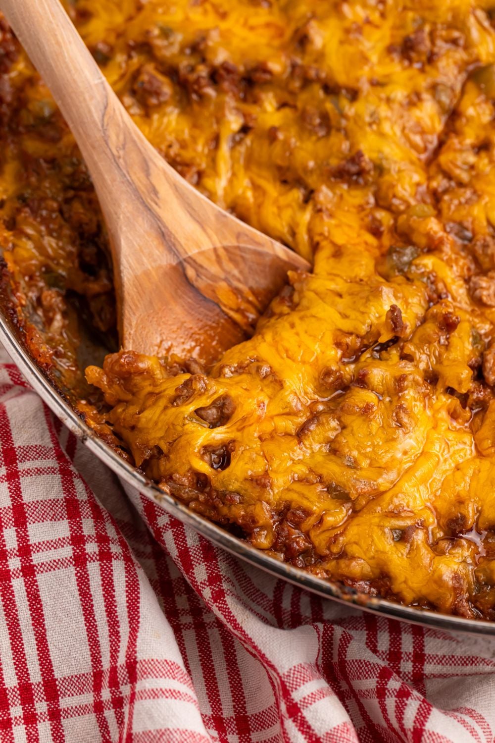 Sloppy Joe Dip in pan with a wooden spoon scooping some out