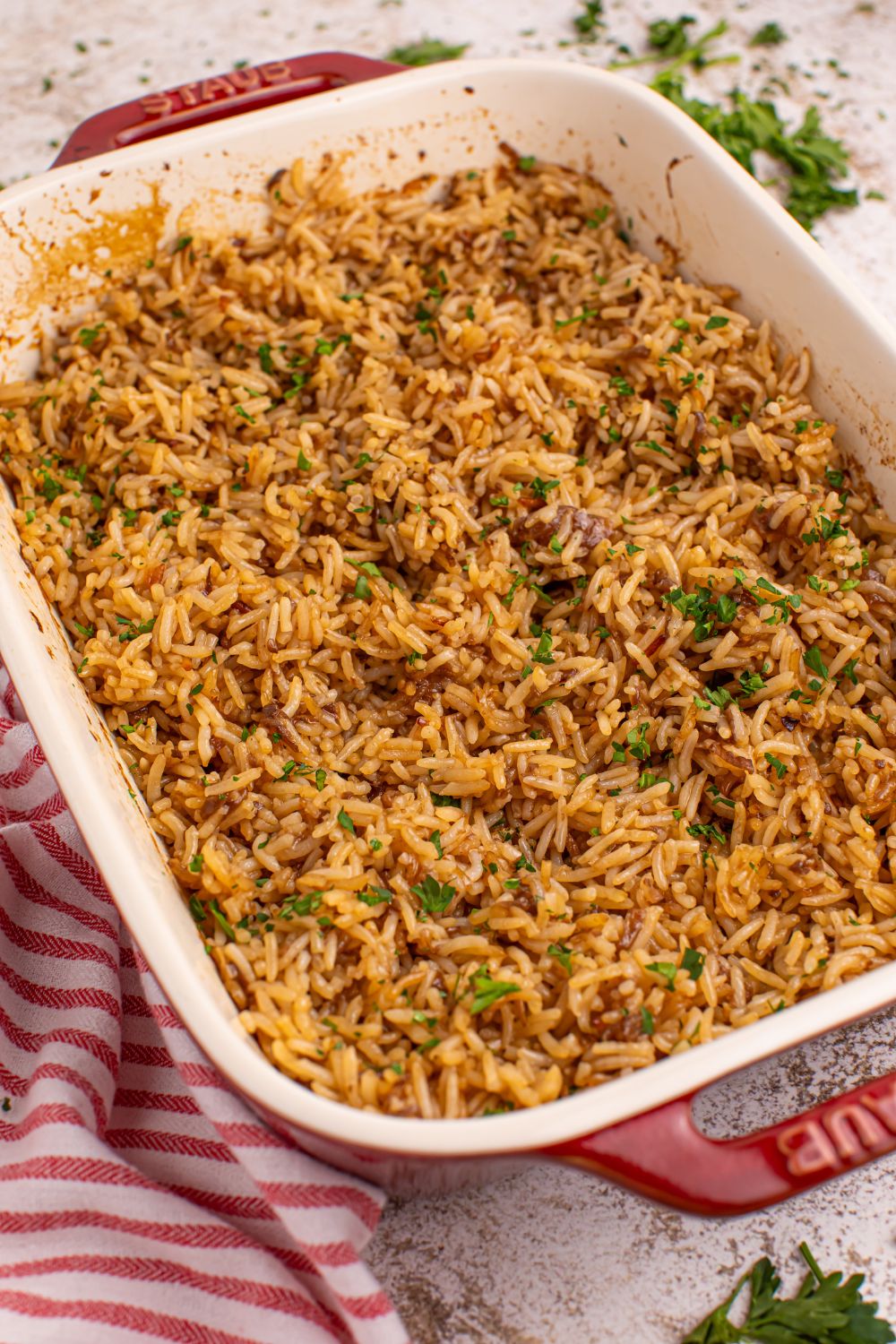 Stick of Butter Rice in a pan with a red striped towel on side