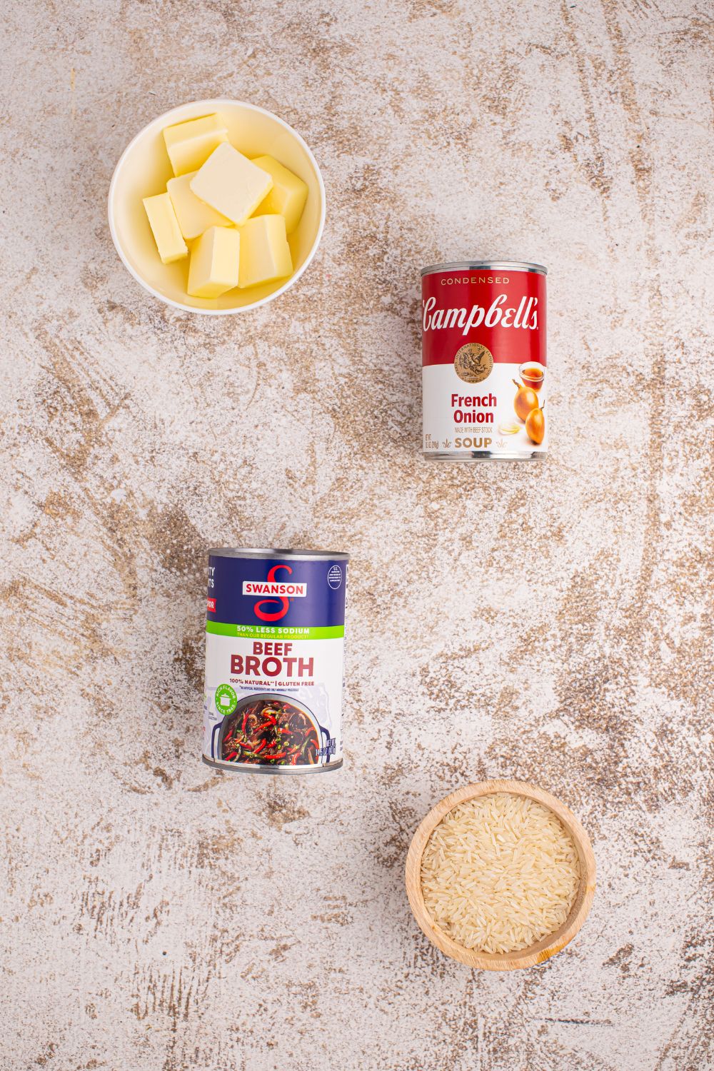 Stick of Butter Rice ingredients on a table in bowls and cans