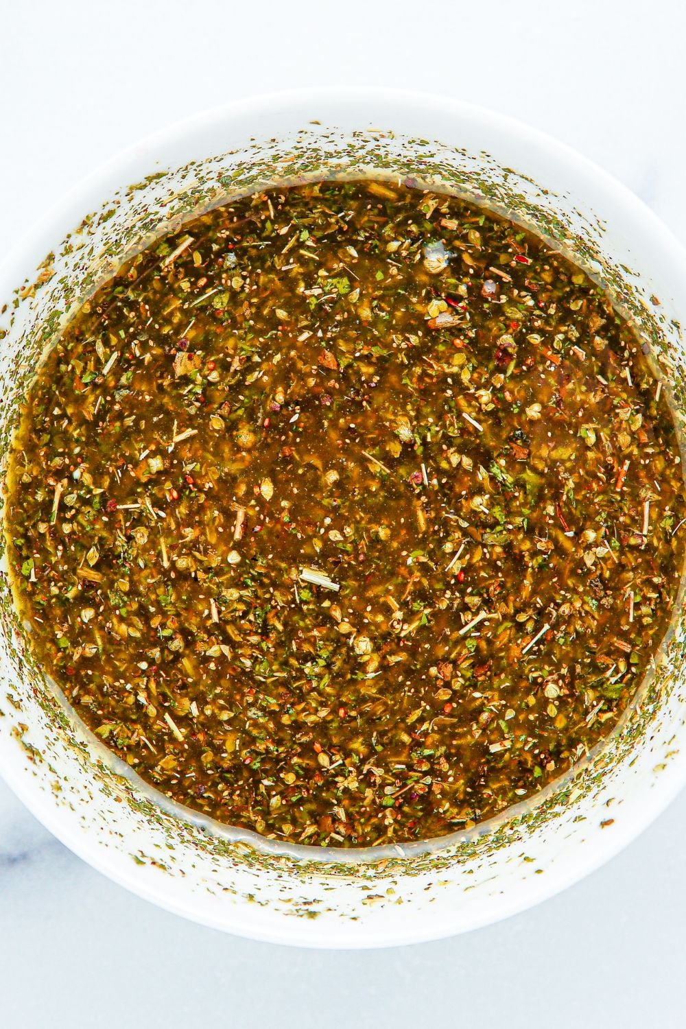 Summer Pasta Salad dressing in a white bowl all mixed up