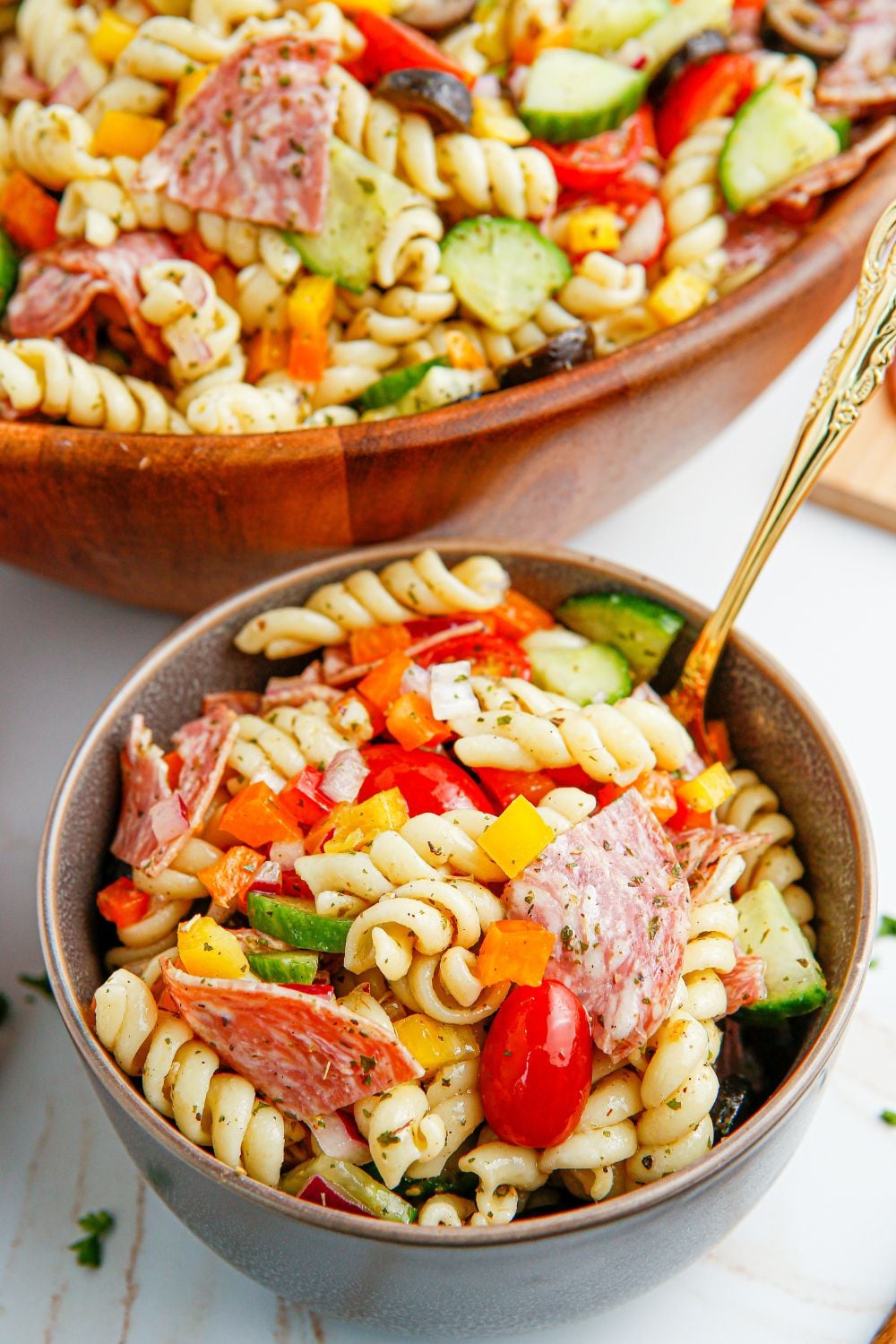 Summer Pasta Salad in a small bowl with a spoon in it 