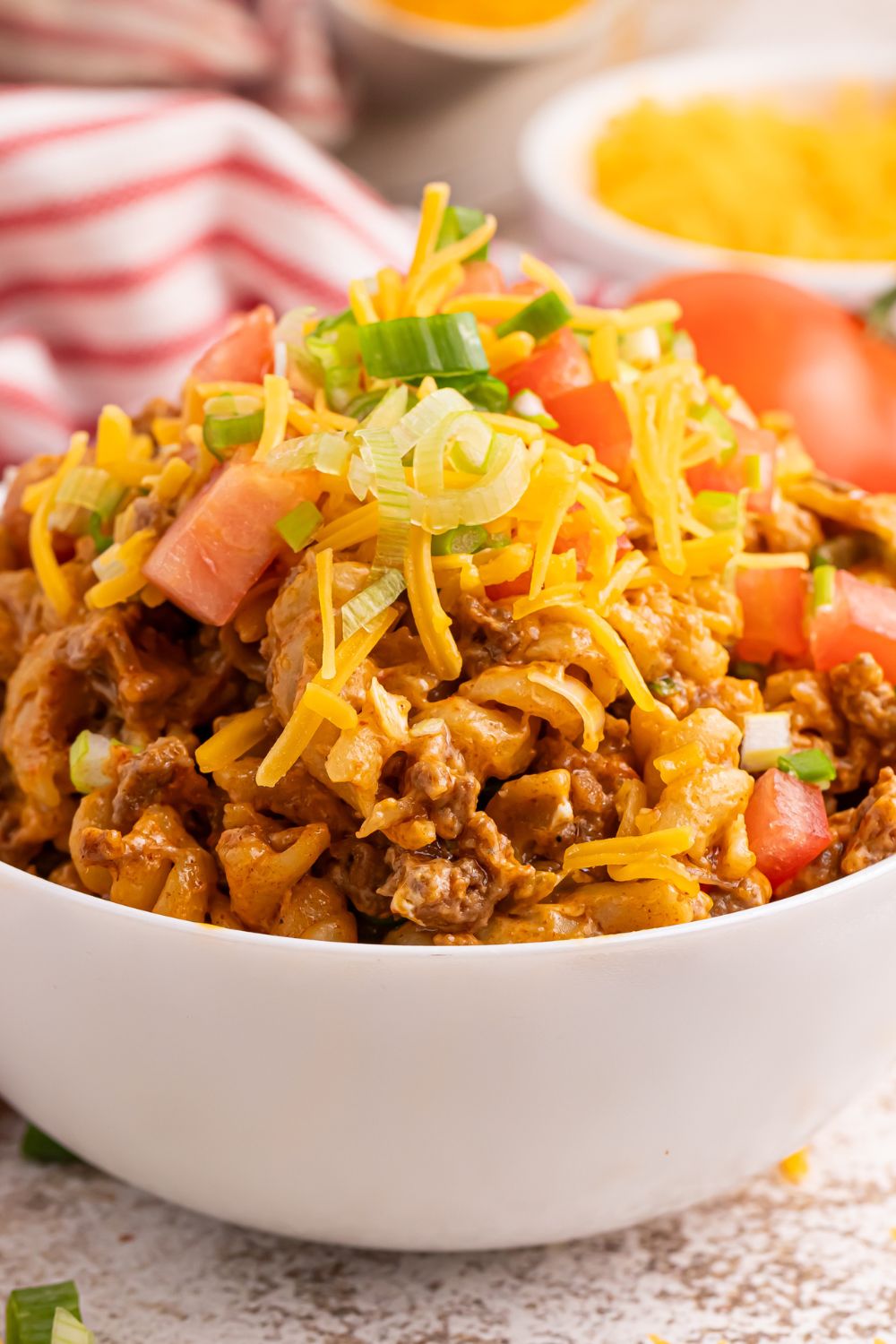 Taco Macaroni and Cheese in a bow with lettuce and tomatoes on it