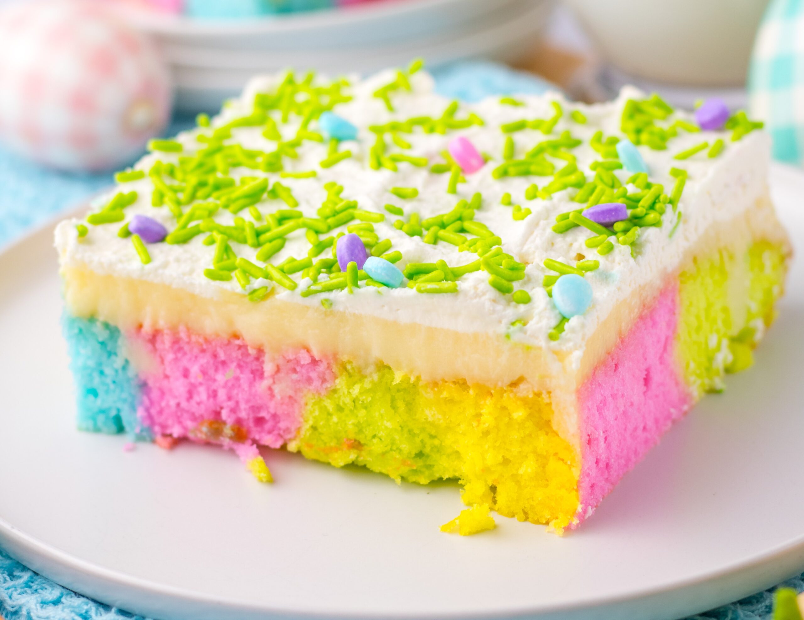 Easter Poke Cake up close on a white plate
