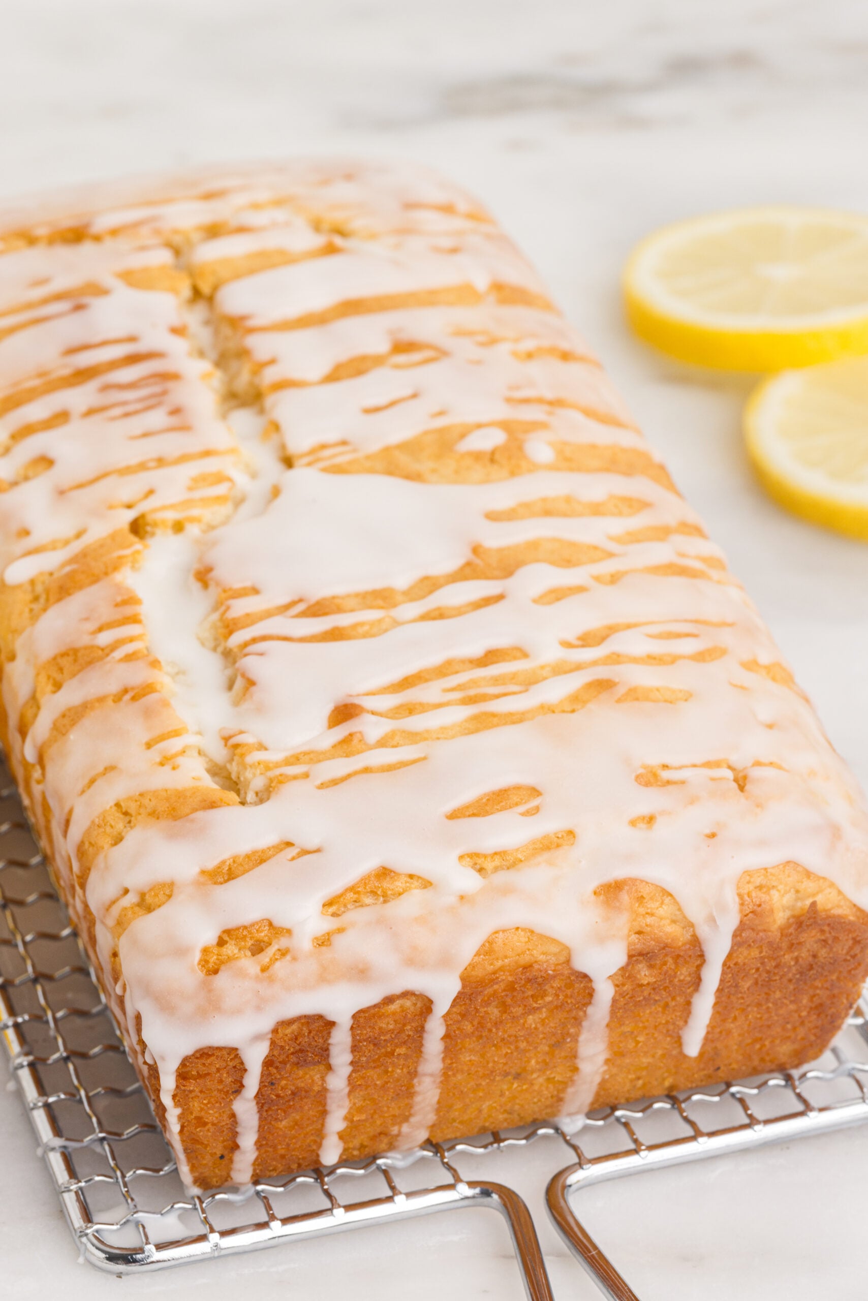 Front view of Lemon Bread on a wire rack showing the close up of the glaze