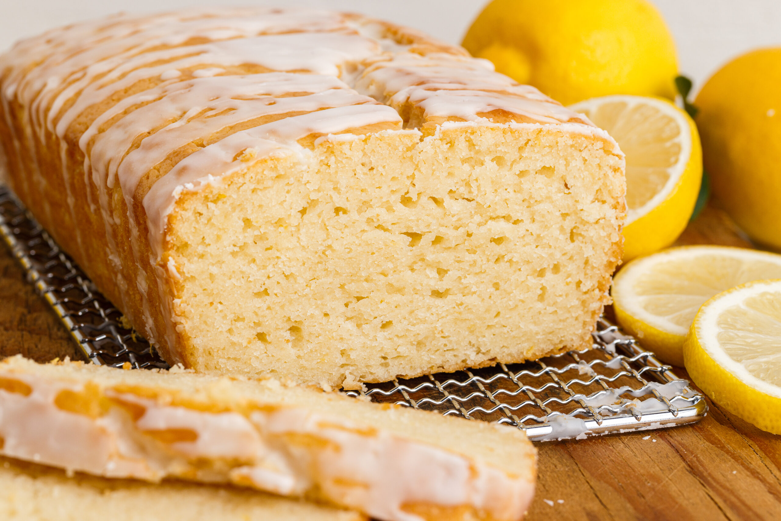 Front view of Lemon Bread on a wire rack with slices removed.