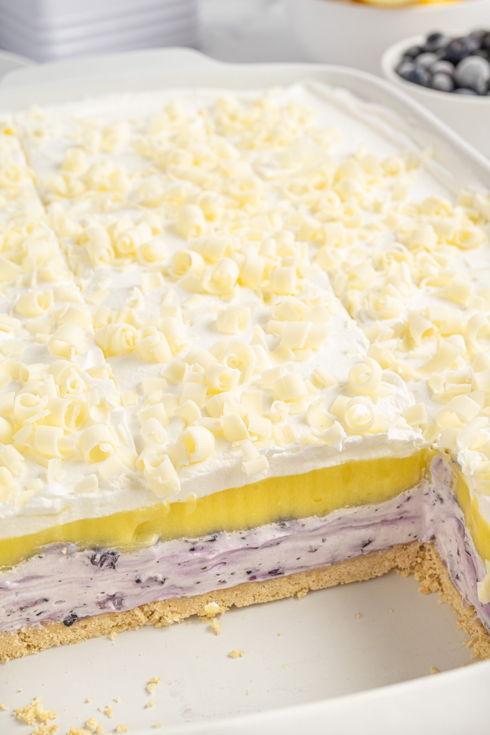 close up look of Lemon Blueberry Lush in pan with a few slices gone