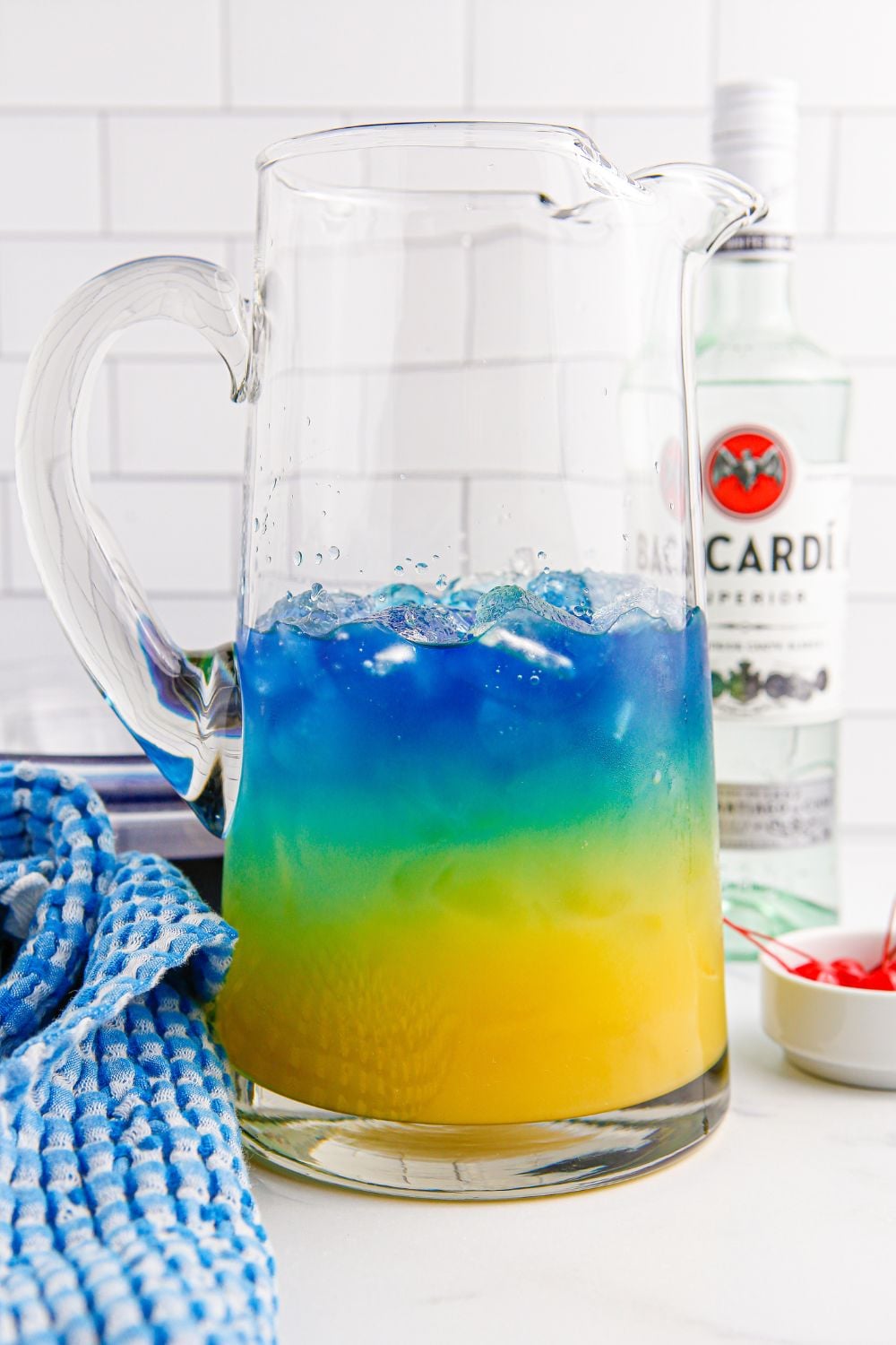 Blue Hawaiian Punch being layered into a pitcher on the table