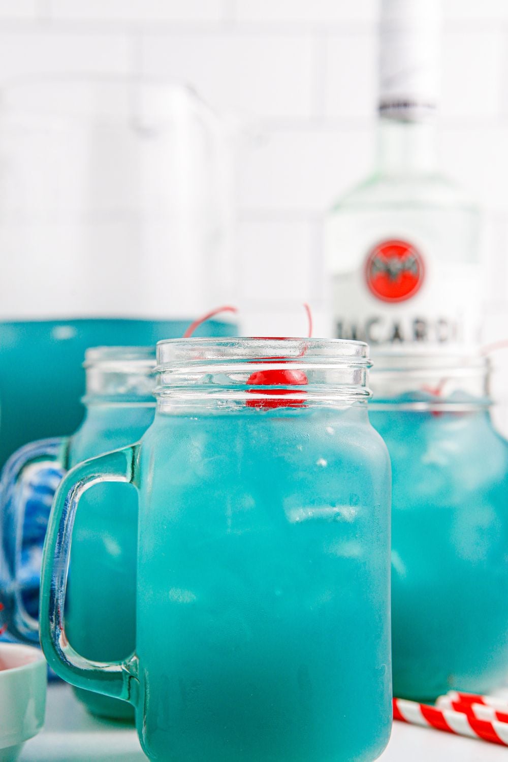Blue Hawaiian Punch in glasses and a pitcher sitting on table