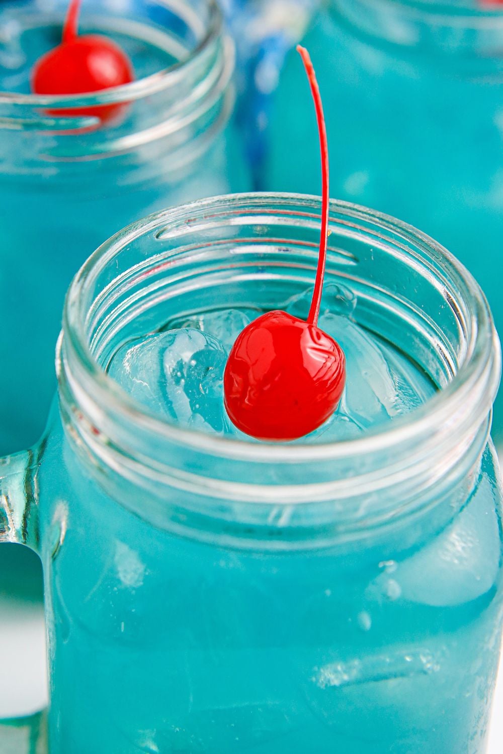 Blue Hawaiian Punch in glasses with a stemmed cherry