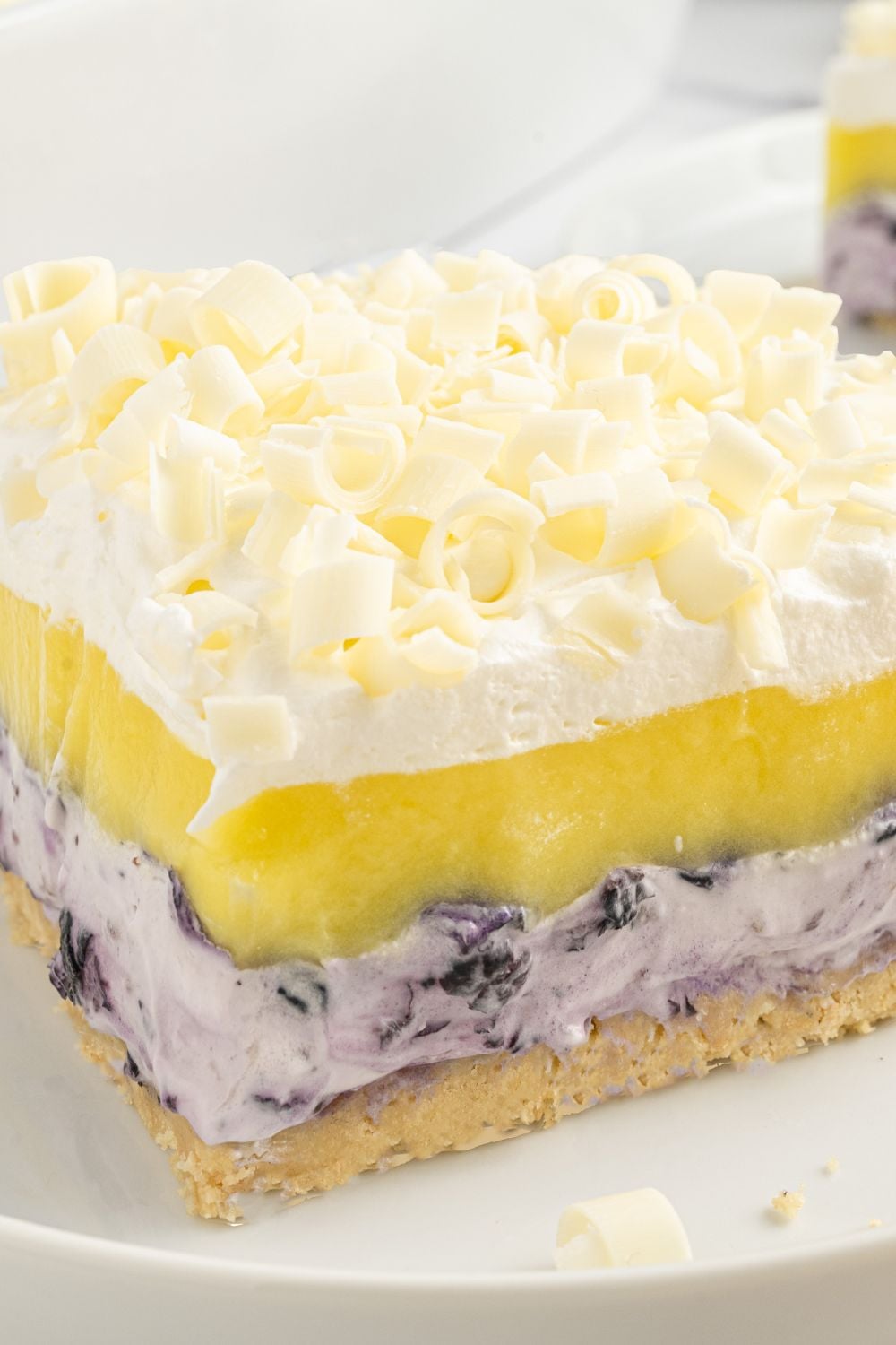close up of side view of a slice of blueberry delight dessert on a plate