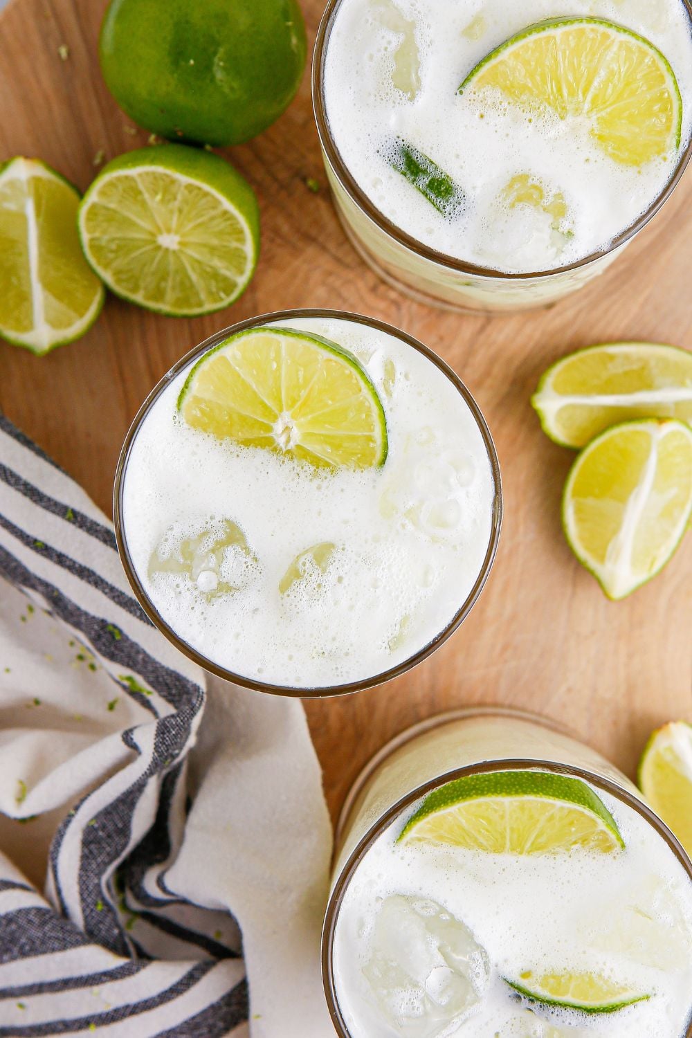 limeades on table with lime wedges around it on table