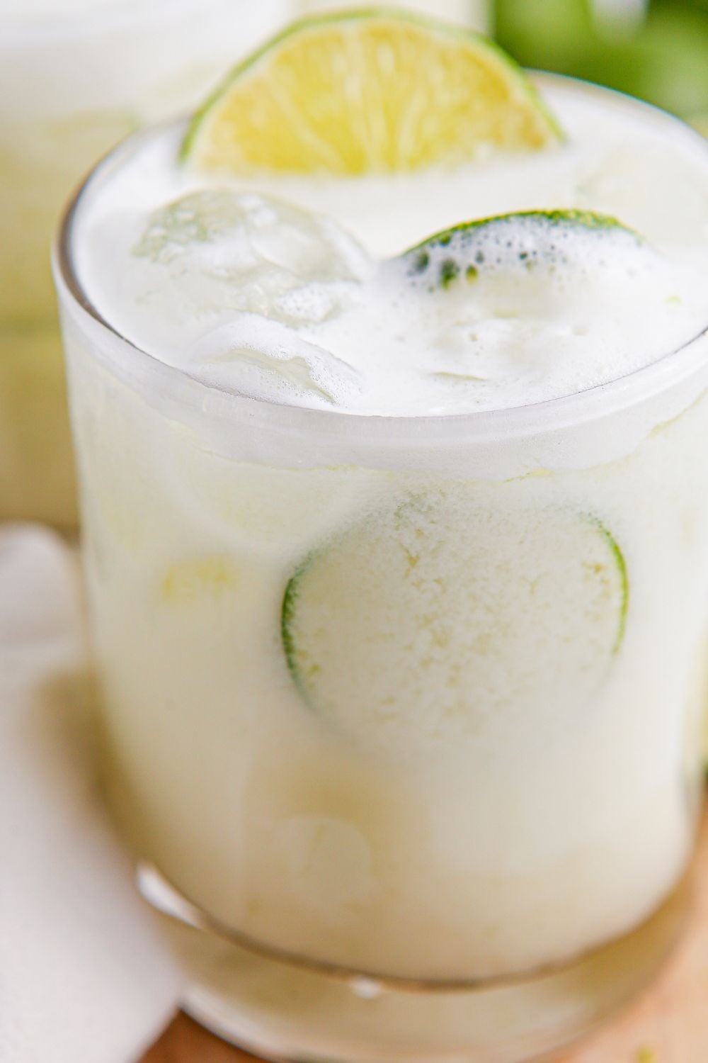 Brazilian Limeade in a glass with some lime slices in glass