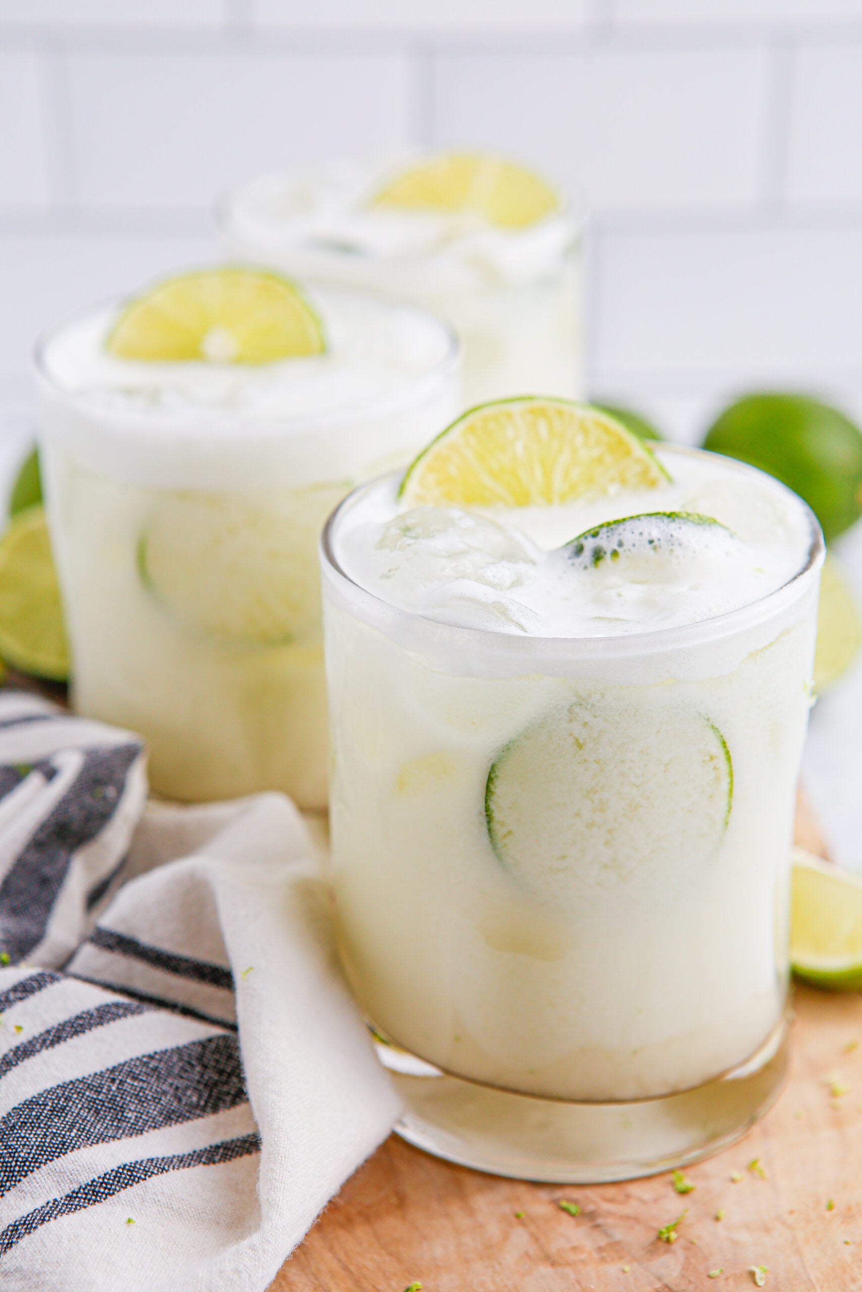 Brazilian Lemonade in clear glasses with sliced limes on top