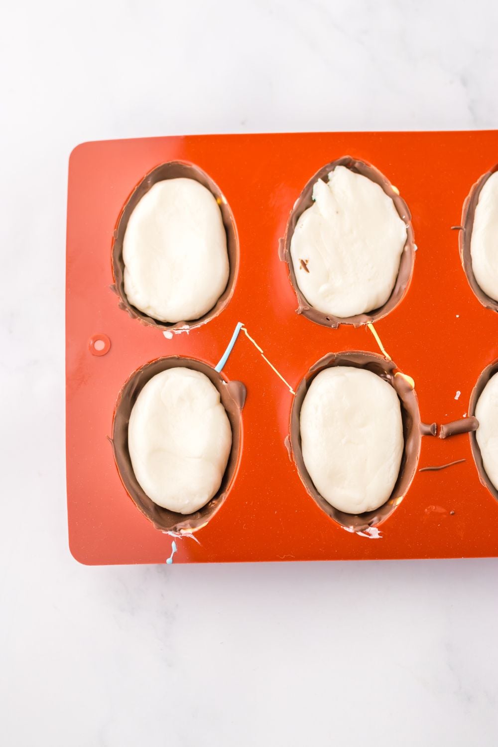 Easter Marshmallow Eggs being assembled in a silicone mold